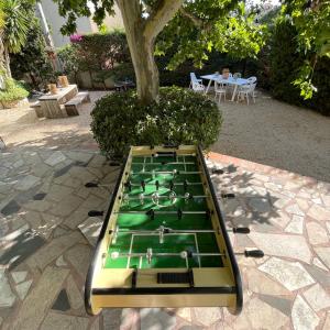 a green pool table sitting on top of a patio at Same Home in Cassis