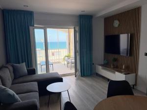 a living room with a couch and a television at Villa Dru in Roquetas de Mar