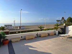 a patio with a view of the beach and the ocean at Villa Dru in Roquetas de Mar