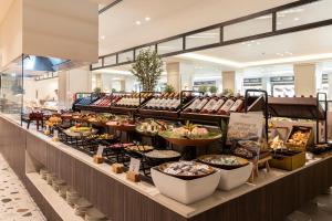 a buffet line with many different types of food at Kerkyra Blue Hotel & Spa by Louis Hotels in Corfu