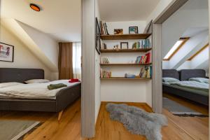a bedroom with a bed and a book shelf at Apartmán JUH in Tale