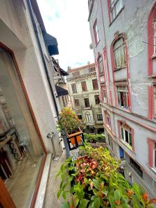 a balcony with a bunch of plants and buildings at Elegance Aparts Cihangir in Istanbul