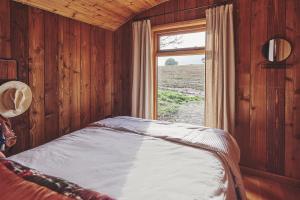 a bedroom with a bed with a window in it at Big Sky Hideaway in Leominster