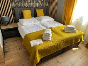 1 dormitorio con 1 cama con toallas en Apartamenty Ustronie Morskie 31B3, en Ustronie Morskie