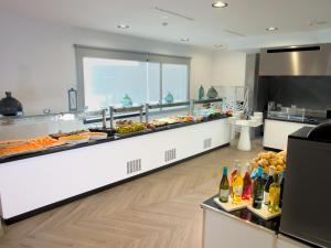 a buffet line with many different types of food at Hotel Taimar in Costa Calma