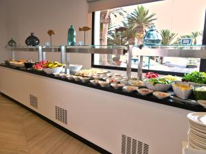 a buffet line with many different types of food at Hotel Taimar in Costa Calma
