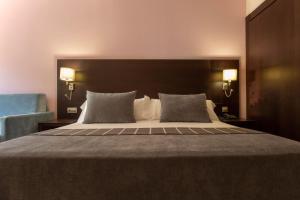 Rúm í herbergi á Hotel Màgic Andorra