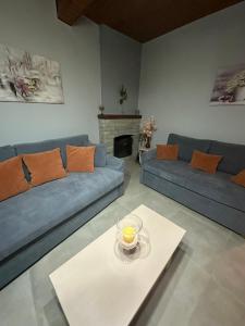 a living room with a blue couch and a table at Casa del sogno in Magouládes