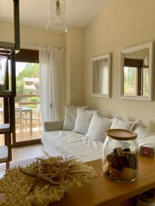 a living room with a couch and a table at Aestas in Neos Marmaras