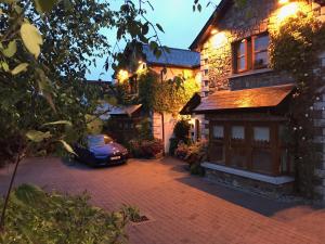 a car parked in front of a brick house at Avlon House Bed and Breakfast in Carlow