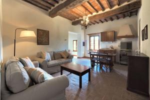 a living room with a couch and a table at Castello di Montalto in Castelnuovo Berardenga