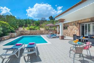 a patio with a pool and chairs and a table at El Tajaral by Vintage Travel in El Gastor