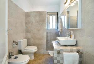 a bathroom with a toilet and a sink at El Tajaral by Vintage Travel in El Gastor +26 photos