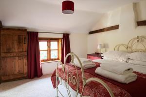 a bedroom with two beds and a window at Church Cottage in Halesworth