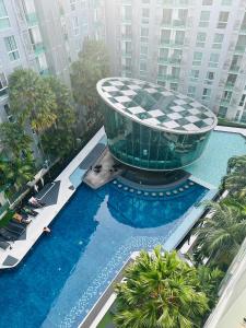 a swimming pool with a building in the middle of a city at City center residents Pool view in Pattaya