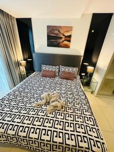 a bedroom with a bed with a teddy bear on it at City center residents Pool view in Pattaya