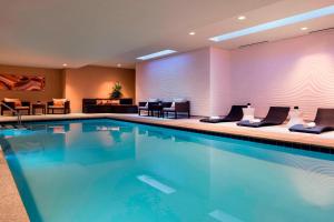 a swimming pool in a hotel room with furniture at Courtyard by Marriott Phoenix Downtown in Phoenix