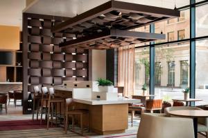 a restaurant with tables and chairs and a large chandelier at Courtyard by Marriott Phoenix Downtown in Phoenix