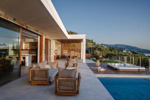 a villa with a patio with a swimming pool at Thesan Villas in Marathias
