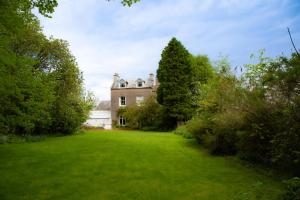an old house with a large yard with trees at Redmayne House in Lake District National Park