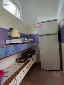 a small kitchen with a stove with pots and pans at Guest House GioRgi in Kobuleti