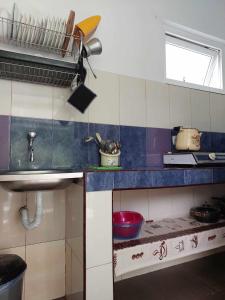 a kitchen with a blue and white tiled wall at Guest House GioRgi in Kobuleti