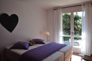 een slaapkamer met een bed en een groot raam bij Villa Abeille : douces vacances d'été avec vue mer in Cavalaire-sur-Mer