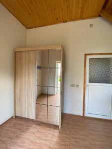 a room with a glass door in a room at KRI Holiday House in Alūksne