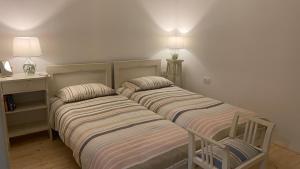 two beds sitting next to each other in a room at Apartments Ivas in Zambratija