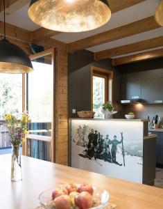 a kitchen with a table with a bowl of apples on it at MarktlAlm - Superior Waldblick Chalet mit Sauna in Turracher Hohe