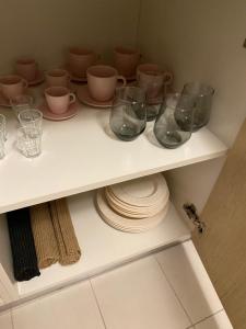 a shelf with cups and plates and glasses on it at Nonna Lenuccia in Noci
