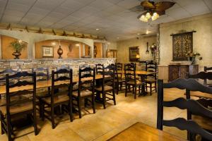 a restaurant with wooden tables and chairs and a bar at Northwest Inn in Woodward