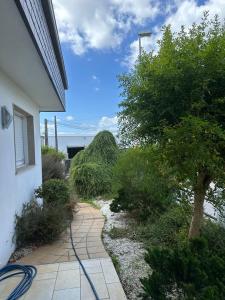 a garden with a hose on the side of a house at Villa Paxariño in Vilagarcia de Arousa