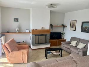 a living room with a couch and a fireplace at Villa Moroni in Sondrio