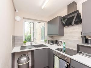 a kitchen with a sink and a stove at Pass the Keys Couples Haven Horsforth in Leeds