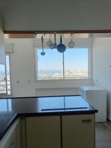 a kitchen with a view of a city from a window at Bella Vista in Haifa in Haifa