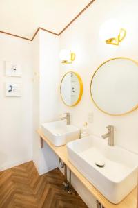 a bathroom with two sinks and a mirror at Meee Asakusa3F4F 浅草徒歩3分 140平米Max22名 無料駐車場 屋上絶景 渋谷直通 in Tokyo +11 photos