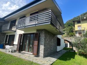 a house with a balcony on the side of it at Villa Moroni in Sondrio