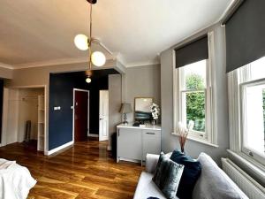 a living room with a couch and a television at Stylish studio near Regent’s Park n7 in London