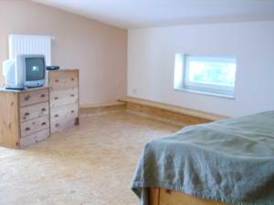 1 dormitorio con cama y vestidor con TV en Ferienhaus DH-38879, en Lubmin 3 fotos más