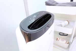 a refrigerator with a trash can in a room at All Stay Inn Seoul in Seoul