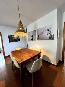 a dining room with a wooden table and chairs at Apartamento en el casco antiguo. in Altea