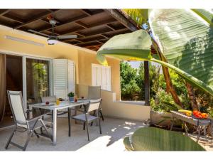 een patio met een tafel en stoelen en een raam bij Anas Kiti Seaside Villa in Menevi
