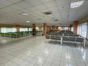 a large room with rows of chairs and tables at Heliconia Park Port Harcourt Hotel and Suites in Port Harcourt +37 photos