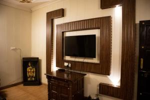 a living room with a flat screen tv on a wall at Ambala Haveli in Ambāla