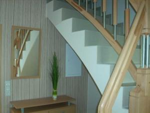 a staircase with a vase with a plant on a table at Ferienwohnungen mit Boot DH-20952 in Lubmin