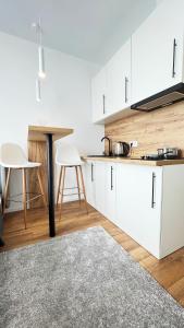 a kitchen with white cabinets and a table at CUBE House in Kyiv