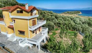 an aerial view of a yellow house with a balcony at Majestic View Resort in Nafpaktos