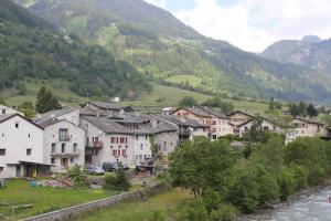 a group of houses in a village next to a river at Hotel Foppoli in Poschiavo
