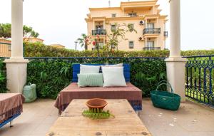a porch with a bed and a table and a building at Apartamento Tocano Beach - By Dalma Portuguesa in Albufeira